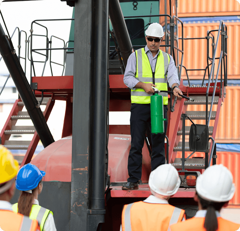 Construction worker demonstrating fire extinguisher use.