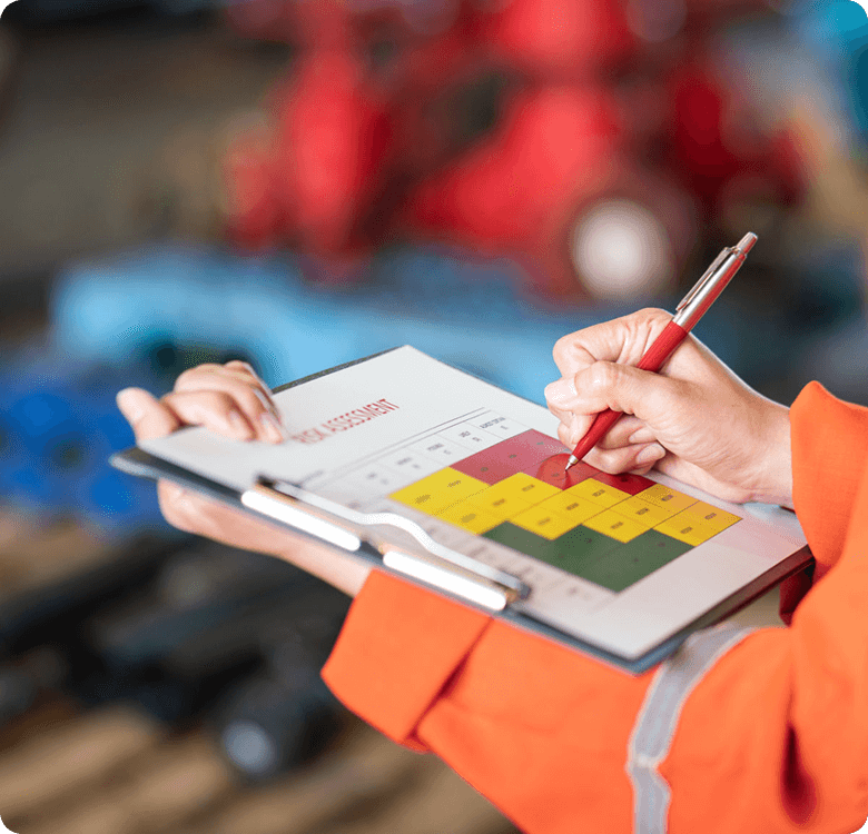 Person marking risk assessment on a clipboard.