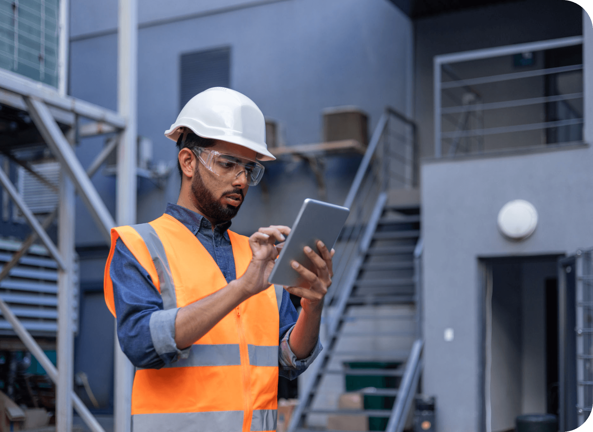 Construction worker using tablet on site.
